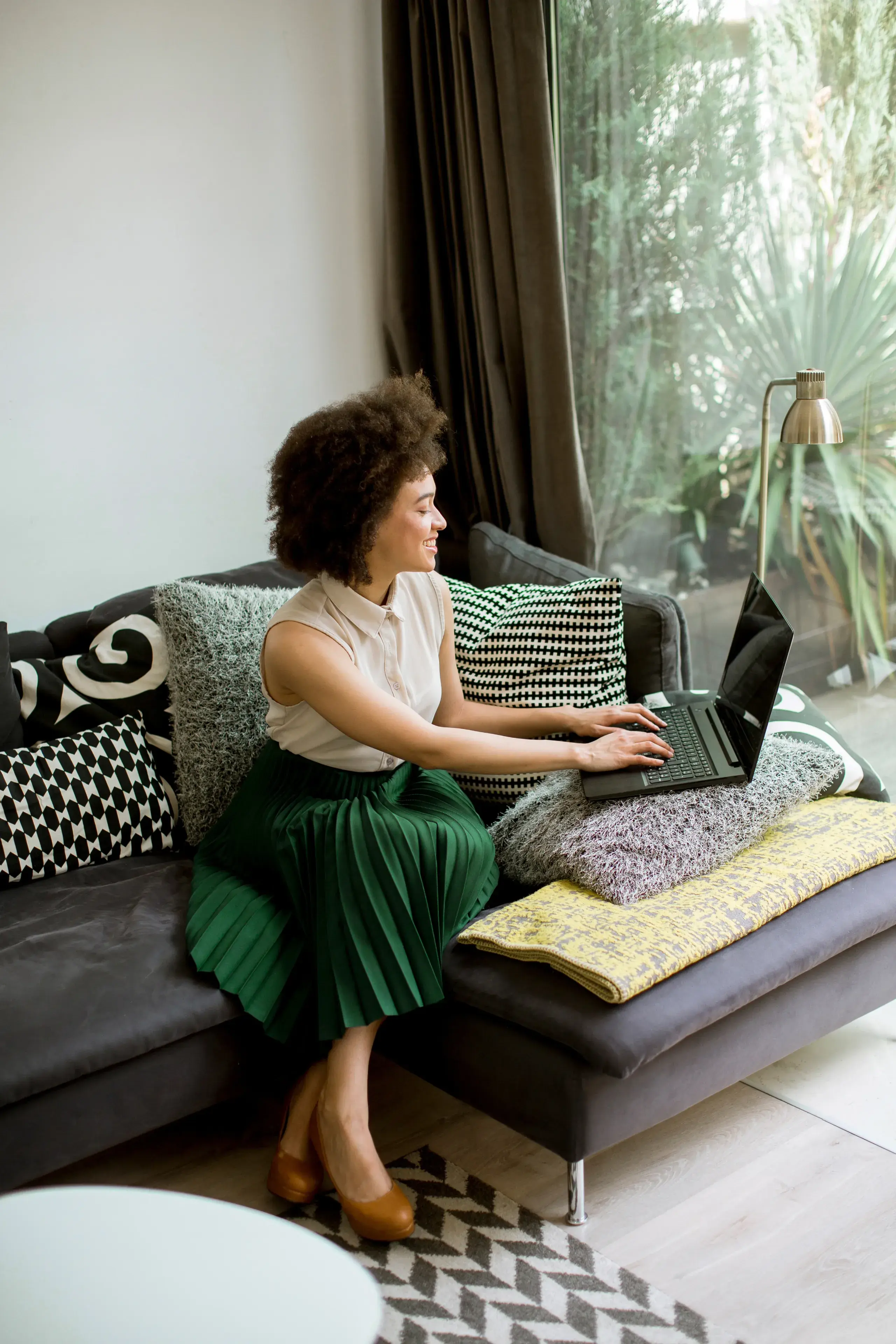 Picture of a lady in front of her laptop happy with we3wire platform